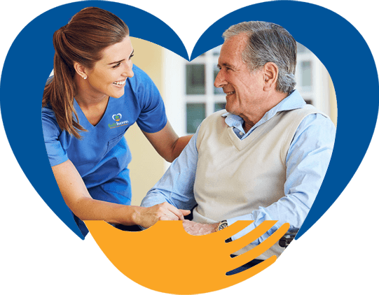 Young female worker smiling at an elderly seated man.