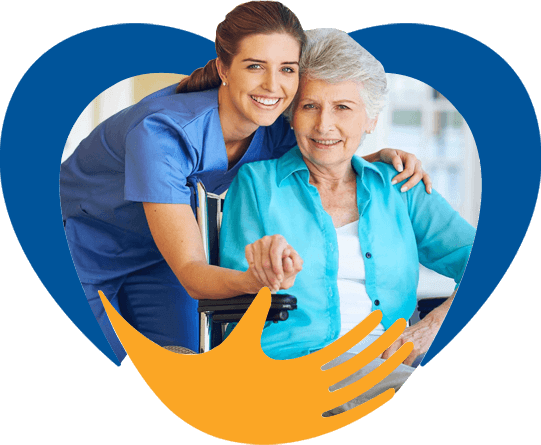 A young female senior services worker embracing an elderly woman in a wheelchair.